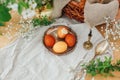 Modern Easter eggs on vintage plate on rustic table with spring flowers,candle, basket. Stylish red and yellow Easter eggs painted Royalty Free Stock Photo