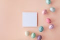Modern Easter mockup with white blank and colorful Easter eggs top view. Flat lay