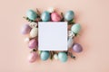 Modern Easter mockup with white blank and colorful Easter eggs with flowers. Flat lay