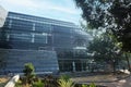 Modern eco-friendly glass architecture and greens against blue sky Royalty Free Stock Photo