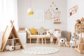 Modern eco-friendly kids room with wooden accents, colorful toys, and a poster mockup in Scandinavian style