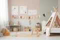 Modern eco-friendly kids room with wooden accents, colorful toys, and a poster mockup in Scandinavian style