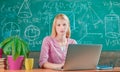 Modern education. Back to school. Remote education. Student adorable blonde girl classroom chalkboard background. STEM