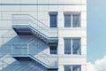 Modern educational building with external fire escape balconies during student emergency drill Royalty Free Stock Photo