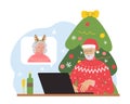 Modern elderly man congratulates woman online using laptop and internet.Christmas and New Year postcard.Distance celebration of