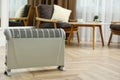 Modern electric convection heater on floor at home. Space for text Royalty Free Stock Photo