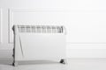 Modern electric convection heater on floor in room, space for text Royalty Free Stock Photo