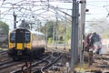 Modern electric emu train passing old steam train