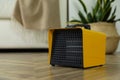 Modern electric fan heater on floor at home. Space for text Royalty Free Stock Photo