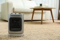 Modern electric fan heater on floor at home. Space for text Royalty Free Stock Photo