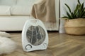 Modern electric fan heater on floor at home. Space for text Royalty Free Stock Photo