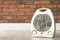 Modern electric fan heater on floor in room, space for text Royalty Free Stock Photo