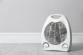 Modern electric fan heater on floor in room, space for text Royalty Free Stock Photo