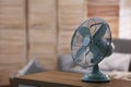 Modern electric fan on wooden table indoors. Space for text Royalty Free Stock Photo