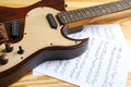 Modern electric guitar and music sheets Royalty Free Stock Photo