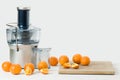 Modern electric juicer and fresh oranges, white background Royalty Free Stock Photo