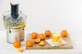 Modern electric juicer and freshly prepared orange juice Royalty Free Stock Photo