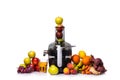 Modern electric juicer, various fruit and glass of freshly made juice, healthy lifestyle concept Royalty Free Stock Photo