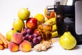 Modern electric juicer, various fruit and glass of freshly made juice, healthy lifestyle concept Royalty Free Stock Photo