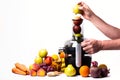 Modern electric juicer, various fruit and glass of freshly made juice, healthy lifestyle concept Royalty Free Stock Photo