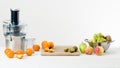 Modern electric juicer and various fruit on kitchen counter, healthy lifestyle