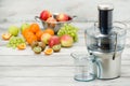 Modern electric juicer and various fruit on kitchen counter, healthy lifestyle