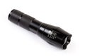 Modern electric LED flashlight in metal housing on white background