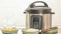 Modern electric multi cooker or Pressure cooker with some ingredients for cooking needs close up