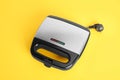 Modern electric sandwich maker on yellow background, above view Royalty Free Stock Photo