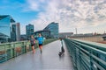 Modern electric scooter in front of modern steel and glass buildings and main train station Haupt Bohnhoff and running people in