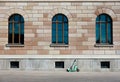 Modern electric scooter leaning on wall of facade of historic stone building as a contrast of old and new