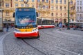 A modern electric tram rounds a corner on the cobbled streets of the old town district of Prague Royalty Free Stock Photo