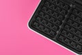 Modern electric waffle maker on pink background, top view. Space for text Royalty Free Stock Photo