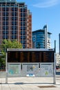 Modern electronic information board with public transport times in the city centre of Oslo