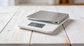 Modern electronic kitchen scale with plate on white wooden table, closeup Royalty Free Stock Photo