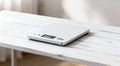 Modern electronic kitchen scale on white wooden table closeup Royalty Free Stock Photo