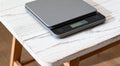 Modern electronic kitchen scale on white wooden table closeup Royalty Free Stock Photo