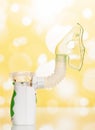 Modern electronic mesh nebulizer with a child`s mask, on lightw background