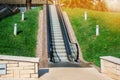 A modern electronic system of many moving on escalator outdoors on a summer day