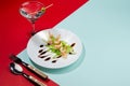 Modern elegant geometric style in food - appetizer of shrimps, greens, celery, teriyaki sauce with martini cocktail with shadow.
