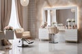 Modern and elegant interior design of professional beauty salon and spa with luxury styling chair Royalty Free Stock Photo