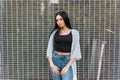 Modern elegant young hipster woman with long gorgeous hair in a black fashionable t-shirt in a summer vintage jacket in jeans Royalty Free Stock Photo