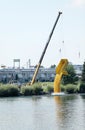 A crane drops rubber ducks into the Snake River.