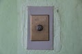 Modern elevator arrow button on old shabby wall