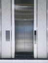 Modern elevator or lift doors made of metal closed in building with lighting