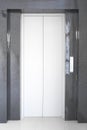 Modern elevator or lift doors made of metal closed in building