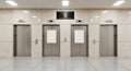 Modern elevator lobby with three doors and a digital display above Royalty Free Stock Photo