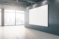 Modern empty interior with blank white mock up banner on concrete wall, windows, city view and daylight. Design and gallery Royalty Free Stock Photo