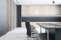 Modern empty meeting room interior with office table and chairs, window, concrete floor and wooden walls. Royalty Free Stock Photo