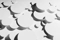 Modern energy motion swarm pattern of white paper ovals different size in hard light with contrast black strict shadows, top view.